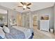 Comfortable bedroom with a ceiling fan, mirrored closet and a view to the ensuite bathroom at 5972 Giardino Ln, Sarasota, FL 34232