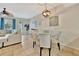 Cozy dining area with a glass-top table, comfortable seating, and stylish lighting at 5972 Giardino Ln, Sarasota, FL 34232