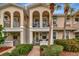 Charming townhome featuring a private balcony, lush landscaping, and elegant architectural details at 5972 Giardino Ln, Sarasota, FL 34232