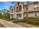 Inviting townhome with landscaped front yard, private balconies, and traditional architectural details at 5972 Giardino Ln, Sarasota, FL 34232