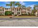 Charming townhome complex with lush landscaping and Mediterranean-style architecture, including balconies and arched entryways at 5972 Giardino Ln, Sarasota, FL 34232