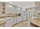 Functional kitchen with white cabinetry, modern appliances, and ample countertop space at 5972 Giardino Ln, Sarasota, FL 34232
