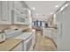 Spacious kitchen featuring white cabinetry, modern appliances, and an open layout to the living area at 5972 Giardino Ln, Sarasota, FL 34232