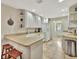 Bright kitchen with an eat-in counter, white cabinets, and views of the rest of the home at 5972 Giardino Ln, Sarasota, FL 34232