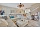 Inviting living room boasts an oversized sectional and open access to the kitchen and staircase at 5972 Giardino Ln, Sarasota, FL 34232