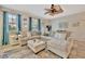 Airy living room with a large sectional sofa, fan, and bright natural light at 5972 Giardino Ln, Sarasota, FL 34232