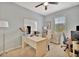 Bright office with a light-colored desk, neutral walls, and a ceiling fan at 5972 Giardino Ln, Sarasota, FL 34232