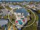 Aerial view showcases waterfront home with private pool, boat dock, and tropical landscaping at 114 Gull Dr, Anna Maria, FL 34216