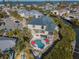 Stunning aerial view of a waterfront home with a private pool, lush landscaping, and a boat dock at 114 Gull Dr, Anna Maria, FL 34216