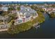 Waterfront property with a private pool, dock, and lush landscaping in a serene coastal setting at 114 Gull Dr, Anna Maria, FL 34216