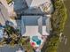 Aerial view showcases the home's unique roof, in-ground pool and waterfront location at 114 Gull Dr, Anna Maria, FL 34216
