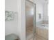 Clean bathroom featuring a glass-enclosed shower, soaking tub, and decorative starfish accents at 114 Gull Dr, Anna Maria, FL 34216