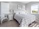 Serene bedroom with a queen-sized bed, white furniture, and a bright window at 114 Gull Dr, Anna Maria, FL 34216