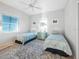 Inviting bedroom with twin beds, coastal décor, and a large patterned rug at 114 Gull Dr, Anna Maria, FL 34216