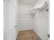 Small closet with white wire shelving, and wood floor at 114 Gull Dr, Anna Maria, FL 34216