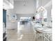 Bright dining room featuring high ceilings, stylish chandelier, and an open floor plan at 114 Gull Dr, Anna Maria, FL 34216
