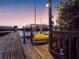Picturesque waterfront dock featuring a boat lift at dusk, offering direct access to the open water at 114 Gull Dr, Anna Maria, FL 34216