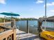Private boat dock with lift, kayak and seating, offering direct access to the water at 114 Gull Dr, Anna Maria, FL 34216