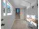 Inviting entryway featuring tiled flooring, neutral paint, and decor elements, including a staircase leading to the upper level at 114 Gull Dr, Anna Maria, FL 34216