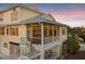 Inviting beach house features a screened-in porch and outdoor dining area at 114 Gull Dr, Anna Maria, FL 34216