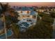 Stunning waterfront home boasts a private pool, balcony, and lush landscaping at 114 Gull Dr, Anna Maria, FL 34216