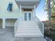 Inviting front entrance with white stairs and railings, leading to double doors at 114 Gull Dr, Anna Maria, FL 34216