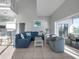 Open-concept living room featuring high ceilings, comfortable seating, and waterfront views at 114 Gull Dr, Anna Maria, FL 34216