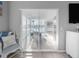 Light-filled room featuring sliding glass doors that open to a waterfront screened patio with a dining set at 114 Gull Dr, Anna Maria, FL 34216