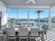 Covered screened patio offering scenic waterfront views, dining set and heater, perfect for outdoor gatherings at 114 Gull Dr, Anna Maria, FL 34216