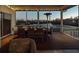 Inviting screened patio with dining set, perfect for entertaining with scenic water views at 114 Gull Dr, Anna Maria, FL 34216