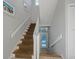 Elegant staircase with carpet runner and white railings leads to upper level at 114 Gull Dr, Anna Maria, FL 34216