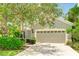 Inviting home with well-maintained landscaping and a spacious attached garage for convenient parking and storage at 11662 Old Cypress Cv, Parrish, FL 34219