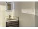 Modern bathroom features a vanity with dark wood cabinetry, a marble countertop, and an illuminated mirror at 1214 Gulf Blvd, Englewood, FL 34223