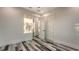 Bright bedroom featuring plank flooring, white trim, and two closet doors at 1214 Gulf Blvd, Englewood, FL 34223