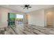 Spacious bedroom with sliding glass doors and wood plank floors at 1214 Gulf Blvd, Englewood, FL 34223
