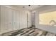 Bright bedroom featuring a modern closet, plank flooring, and white trim at 1214 Gulf Blvd, Englewood, FL 34223