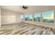 Bright bedroom with large windows offering an ocean view, wood-look flooring and a ceiling fan at 1214 Gulf Blvd, Englewood, FL 34223