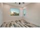 Bright bedroom featuring two windows, plank flooring, and white trim at 1214 Gulf Blvd, Englewood, FL 34223