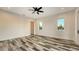 Spacious bedroom featuring two windows and wood plank flooring at 1214 Gulf Blvd, Englewood, FL 34223