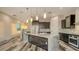 Modern kitchen features a large island with marble countertops, pendant lighting, and stainless steel appliances at 1214 Gulf Blvd, Englewood, FL 34223