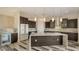 Open-concept kitchen featuring a large island, modern lighting, and stainless steel appliances at 1214 Gulf Blvd, Englewood, FL 34223