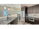 Kitchen featuring white and stainless steel appliances, marble backsplash and sink with modern faucet at 1214 Gulf Blvd, Englewood, FL 34223