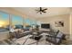 Bright living room boasts large windows, a comfortable sofa, stylish chairs and a decorative rug at 1214 Gulf Blvd, Englewood, FL 34223