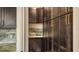 Pantry with dark wood cabinets, gold hardware, and marble countertops at 1214 Gulf Blvd, Englewood, FL 34223