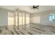 Bright room features wood-look floors, white walls, and natural light at 1214 Gulf Blvd, Englewood, FL 34223