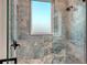 Elegant glass shower enclosure highlighted by marble-patterned tiles and contemporary fixtures at 1214 Gulf Blvd, Englewood, FL 34223