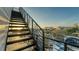 Metal staircase with scenic views, black railings and diamond plate steps at 1214 Gulf Blvd, Englewood, FL 34223