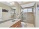 Modern bathroom with tiled shower, vanity with sink, and updated fixtures for a fresh appeal at 1227 Tuscany Blvd, Venice, FL 34292