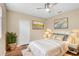 Cozy bedroom with neutral walls, white rug, ceiling fan and decorative wall art at 1227 Tuscany Blvd, Venice, FL 34292