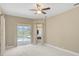 Bright bedroom with pool view through sliding glass door and a cozy, neutral color palette at 1227 Tuscany Blvd, Venice, FL 34292